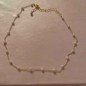 This is a gold pearl necklace